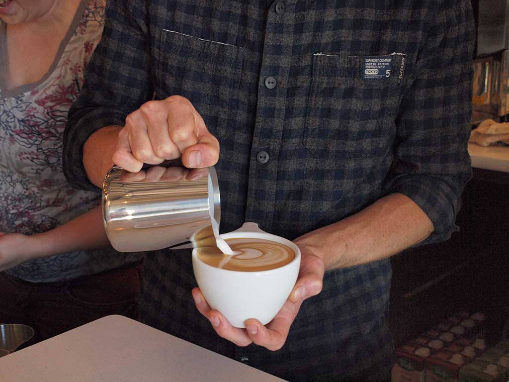 Pouring a latte at Case Study Coffee on Albert Street in Portland, Oregon